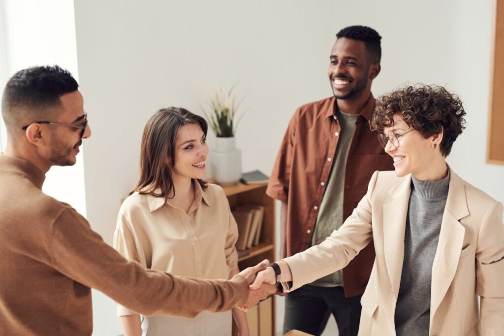 People smiling and shaking hands