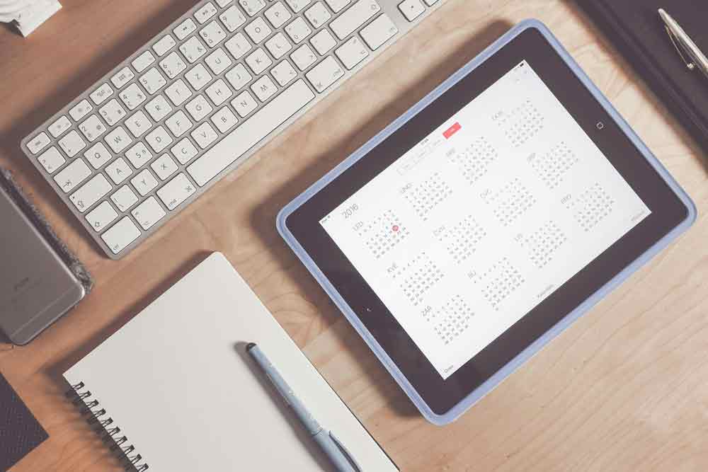 An iPad with a digital calendar for scheduling appointments.